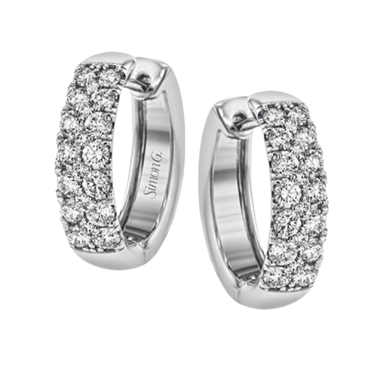 The clean design of these white gold earrings is elevated by 1.05 ctw of sparkling round white diamonds
