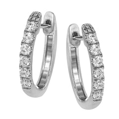 These timeless 18k white gold hoop earrings are set with .55 ctw of dazzling white diamonds.
