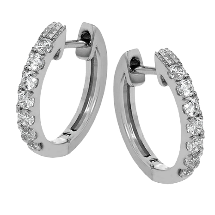 These petite hoop earrings are formed in 18k white gold and set with .30 ctw of scintillating round white diamonds.