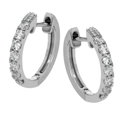 These petite hoop earrings are formed in 18k white gold and set with .30 ctw of scintillating round white diamonds.