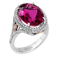 A beautiful 7.55 ct oval rubellite sits at the center of this enchanting 18k white gold ring with accents of 18k rose gold. A beautiful .70 ctw of white diamonds finishes this lovely design.