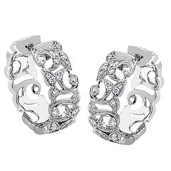 These traditional white gold hoop earrings reflect a romantic floral openwork design accented with .37 ctw of shimmering white diamonds.