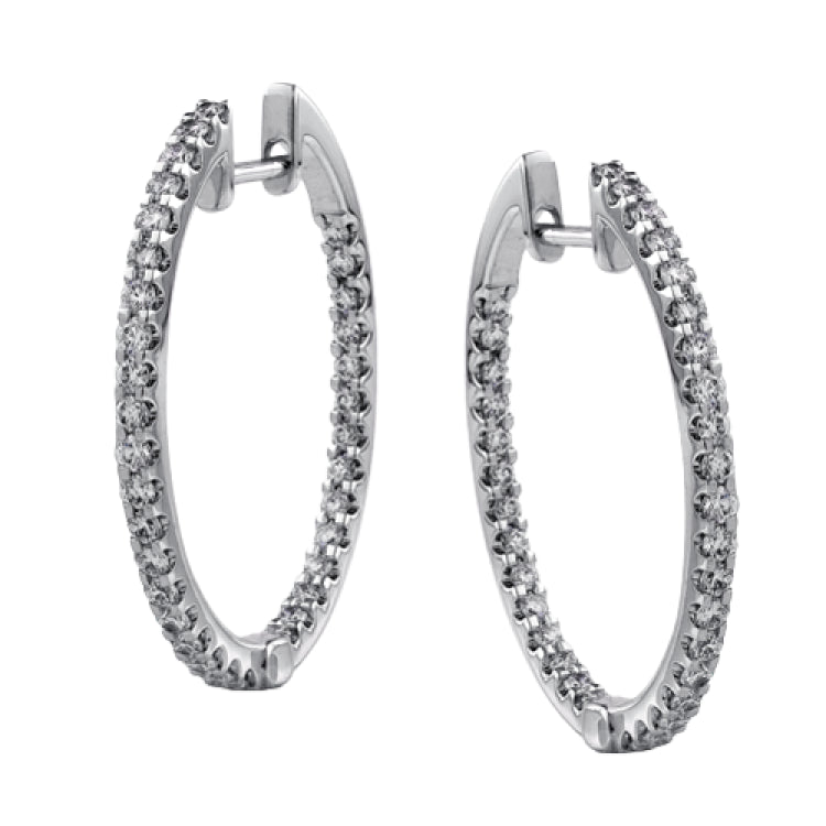 Featuring a classic hoop style, these white gold earrings are accented with .85 ctw of gleaming round cut white diamonds.
