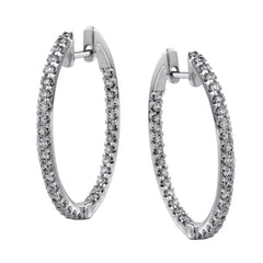 Featuring a classic hoop style, these white gold earrings are accented with .85 ctw of gleaming round cut white diamonds.